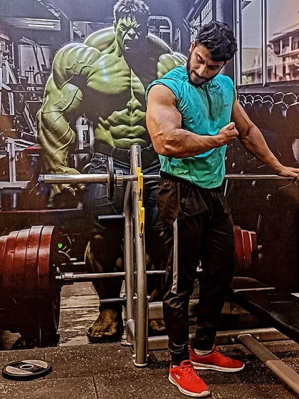 It's a matter of time. I will change the time. A bicep pose in front of a Hulk mural.