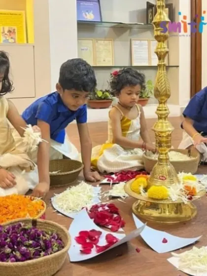 Children in traditional Onam attire prepare flower petals for the Pookalam. Dressing up for festivals adds to the excitement and helps them connect with the cultural significance of the day.