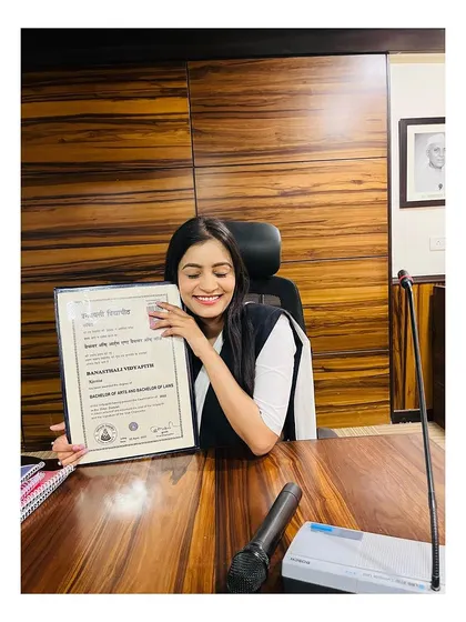 At my desk, proudly displaying my Bachelor of Arts and Bachelor of Laws degree. It symbolizes the foundation of my legal career and my commitment to justice.