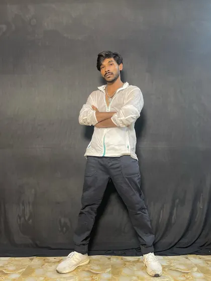 A strong, confident pose against a black backdrop.