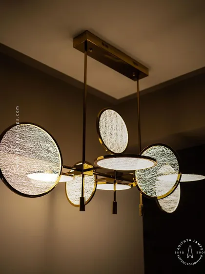 This artistic chandelier is composed of multiple circular discs with a unique woven texture. The layered arrangement and soft backlighting create a beautiful interplay of light and shadow, making it a captivating centerpiece.