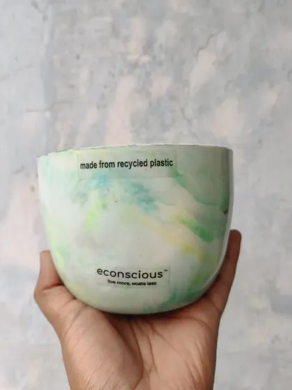 This beautiful bowl-shaped planter, with its soft green and yellow marble pattern, is made from 150 grams of recycled plastic. It's a perfect home for a small plant and a great conversation starter.
