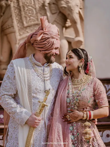 A happy portrait of the couple after their Anand Karaj ceremony at The Raj Palace.