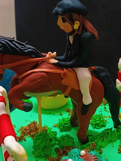 A close-up of the handcrafted horse and rider, showcasing the intricate fondant work.