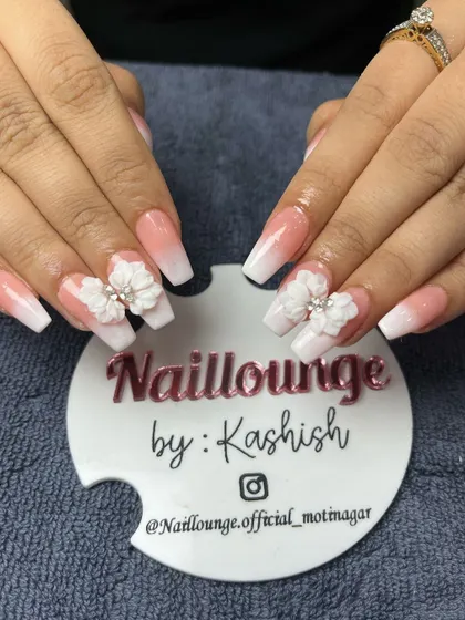 A classic white ombre on coffin nails, made special with beautiful 3D floral embellishments.