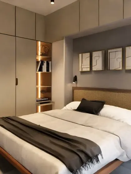 This concept for a 1BHK apartment explores the use of flexible furniture, like a folding bed, to augment the space. A sliding panel with a tropical mural conceals the bed when not in use, transforming the room from a bedroom into a spacious living area.
