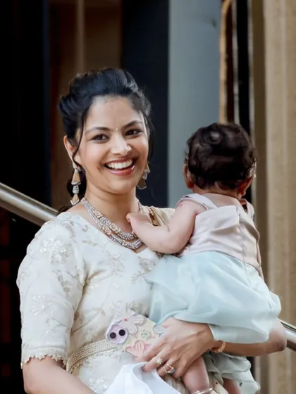 A heartwarming photo of Shriya with her baby. Her makeup is soft and natural, perfect for a family occasion.