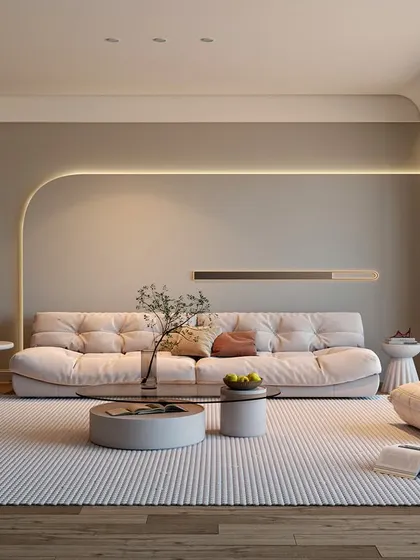 A wider view of the minimalist living room, showing the clean lines and uncluttered layout. We used integrated LED lighting along the curved wall to add a soft, ambient glow, enhancing the room's tranquil and sophisticated character.