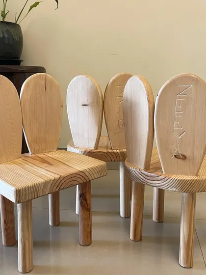 A set of my handcrafted bunny chairs, ready to be delivered. You can see the beautiful natural grain of the pine wood and the custom name engravings on each one.