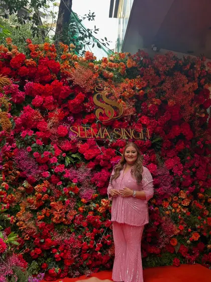 For the grand opening of the Seema Singh showroom, I designed this magnificent floral wall as a backdrop. The dense tapestry of red, pink, and orange flowers created the perfect celebratory and photogenic moment. Here I am with the host of the evening.