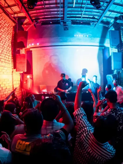 A wide shot of the stage and crowd at Roxy, Kolkata, during the high-energy Pujo season.