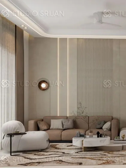A lobby in a Model Town residence, designed with soft, curved furniture and a combination of fluted panels and ambient lighting to create a serene and elegant space.