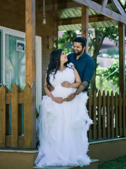 A cozy and intimate moment from a maternity shoot at a rustic cabin. The client is wearing my white ruffled gown, which looks angelic and pure.