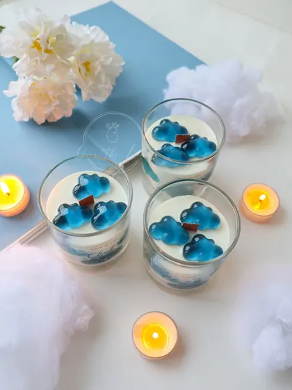 A trio of my 'Cloud 9' jar candles. The layered blue and white wax looks like a dreamy sky in a glass.