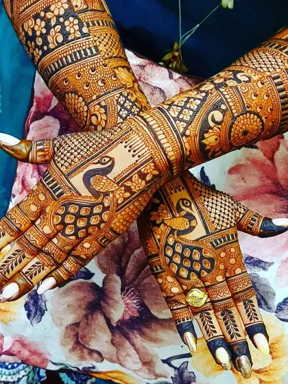 A stunning back-hand design focused on peacock motifs. The feathers of the peacock flow beautifully across the hand, creating a design that is both bold and elegant.