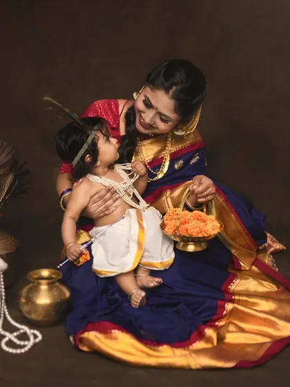 A mother in a beautiful Kanchivaram saree shares a loving gaze with her little Krishna. I love incorporating family heirlooms and traditional wear to make these portraits deeply personal.