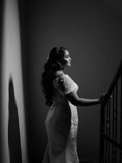 A stunning black and white photo that captures the timeless elegance of the bride's silhouette and hairstyle.