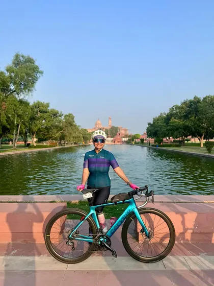 Posing by the water with her bike.