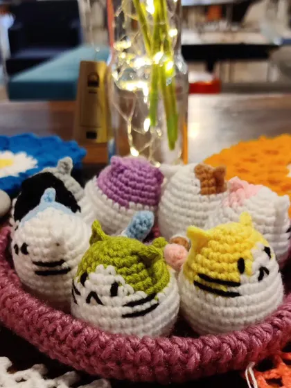 A basket of my colorful cat keychains, a bestseller at my stall.