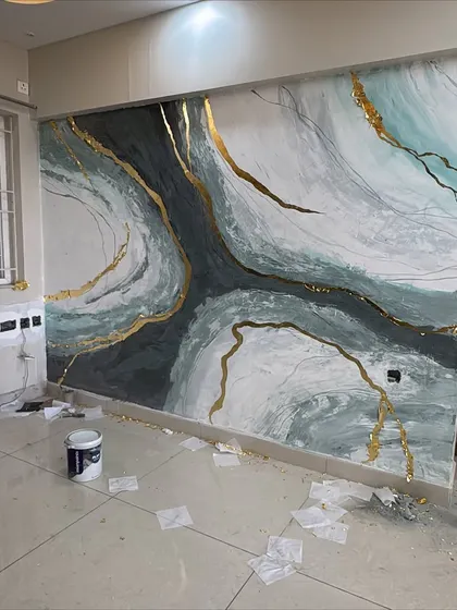 The work in progress! This shot shows the granite mural just after we've applied the gold foil. You can see the scattered foil pieces on the floor before we brush away the excess, revealing the clean, crisp golden lines.