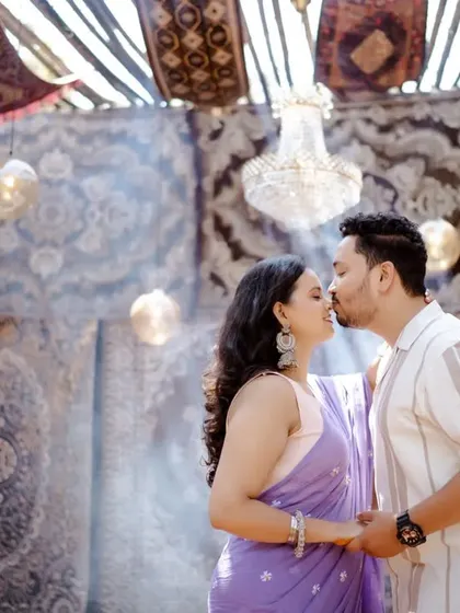 A romantic kiss in a beautifully decorated, tent-like structure. The soft light and intricate patterns of the carpets create a magical, Arabian Nights-inspired ambiance.