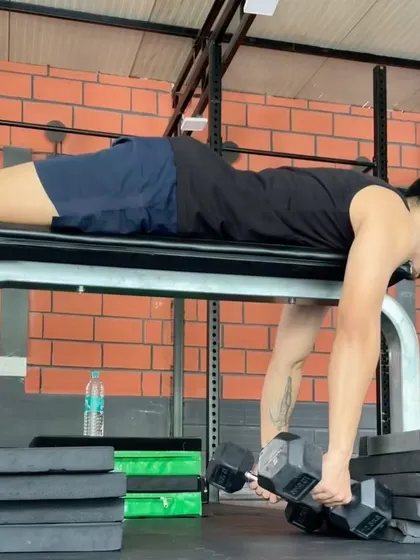 Another angle of the prone dumbbell row, focusing on squeezing the shoulder blades together at the top of the movement.