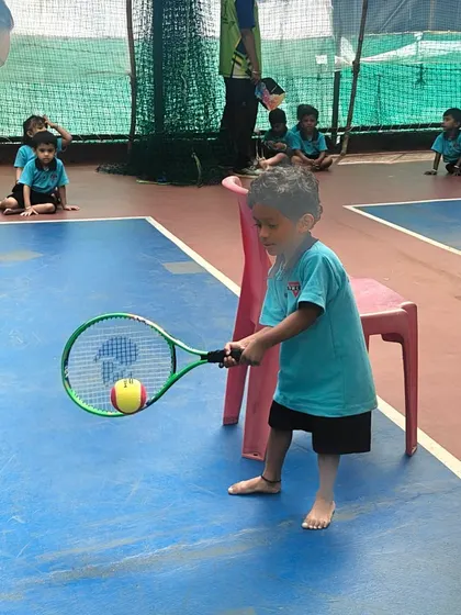 Practice makes perfect. This young player is working on his swing path and balance during a mini-tennis session, a key part of our junior tennis development program.