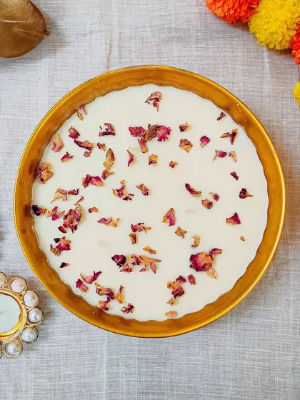 A top-down view of our rose petal candle bowl, showing the delicate scattering of real dried roses.