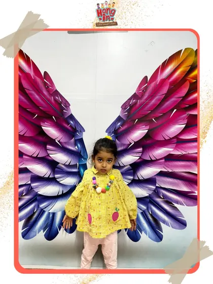 This little one looks adorable posing with our vibrant feather wings. These fun photo opportunities are just one part of the happy experience we create.