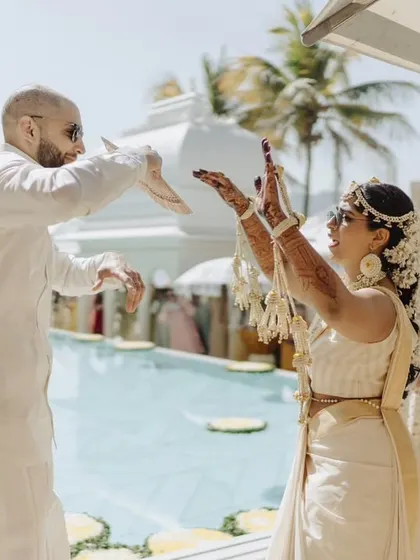 A fun-filled Haldi ceremony in Udaipur, where the couple, dressed in traditional white and gold, danced and celebrated by the pool.
