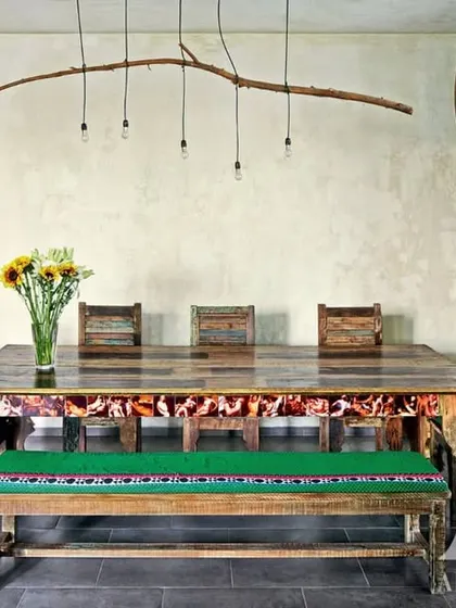 The dining area in Kangana's home, where a light fixture made from a natural tree branch hangs above a rustic table. This space is a perfect example of bringing organic, earthy elements indoors to create a grounded and soulful atmosphere.