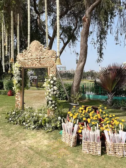 A wider view of the photo booth area, with baskets of traditional white umbrellas for guests to use.