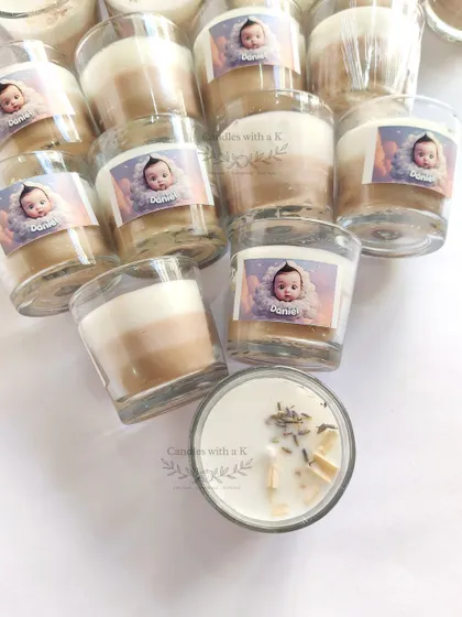 Layered votive jar candles in neutral tones, personalized with a photo for a Baptism ceremony in Kerala.