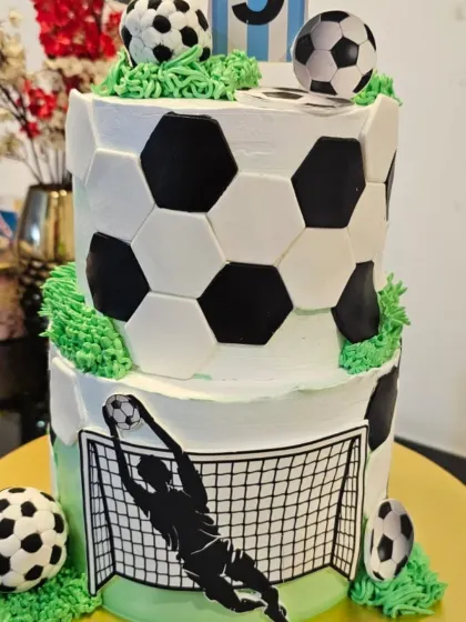 A still photo of the two-tier football cake. It's a great centerpiece for any soccer-themed birthday party.