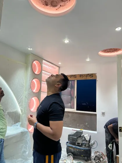 A close-up inspection of the lighting and finish on the ceiling and wall panels.