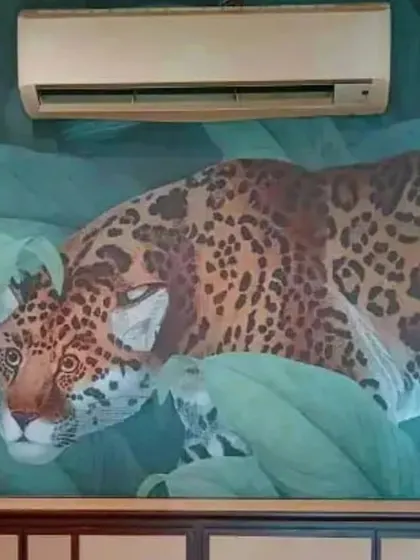 A close-up of a leopard wallpaper mural, showcasing the rich detail and color. This type of bold, nature-themed design is perfect for making a statement in a themed room or commercial space.