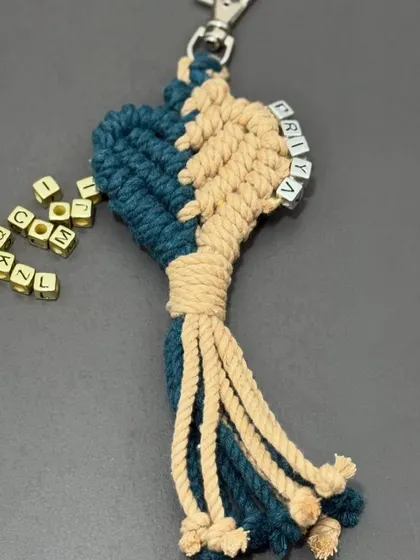 A close-up of a personalized keychain with the name 'PRIYA' spelled out in letter beads. I can customize these with any name!