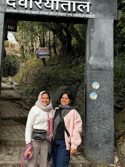 Two travelers at the entrance of the Deoriatal trek. Our trips are perfect for friends looking to embark on a beautiful journey together.