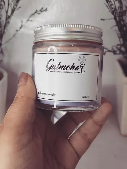 Holding one of my custom-labeled jar candles. These are a great option for creating your own branded product line.