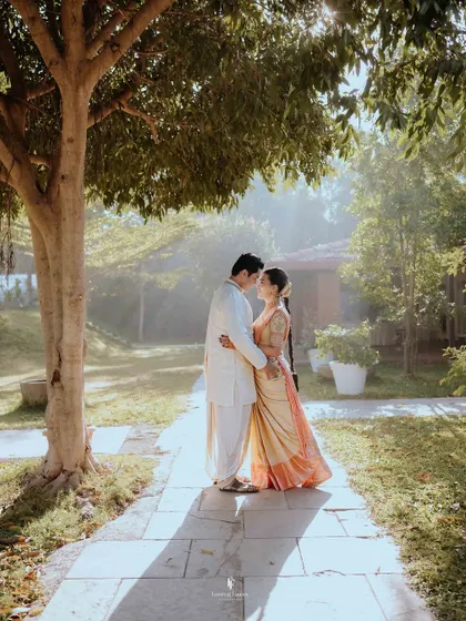 An intimate portrait of the couple under a tree, with the sun creating a beautiful flare. This kind of romantic, naturally lit shot is a signature of my style.