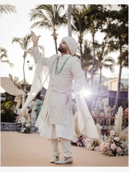 A stylish pose from the groom during his entrance.