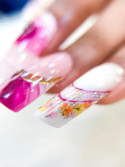 This image shows the floral inbuilt nail alongside other abstract designs, demonstrating how to create a cohesive yet varied full set.