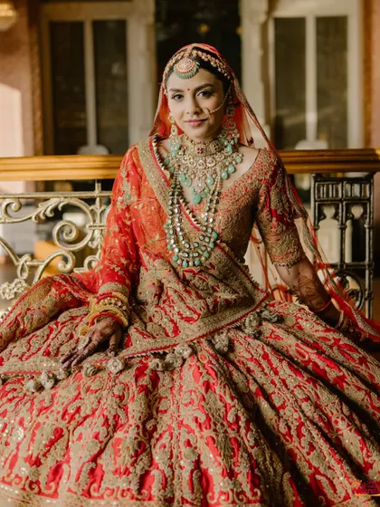 A close-up of the bride, showcasing her intricate jewelry and the serene, happy expression of a woman in love.