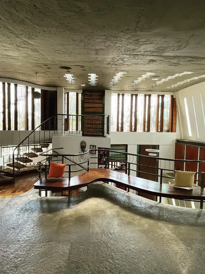 We believe buildings can talk, especially through the interplay of light and form. Here, sunlight streams through carefully placed openings, interacting with the home's organic, flowing structure to create a dynamic and ever-changing atmosphere.
