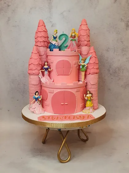 A fairytale dream come true, this two-tiered Disney princess castle cake was made for a second birthday. The towers and details are all handcrafted to create a magical centerpiece.