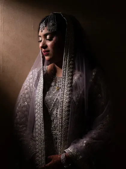 A dramatic bridal portrait using shadow and light to create a moody and elegant look.