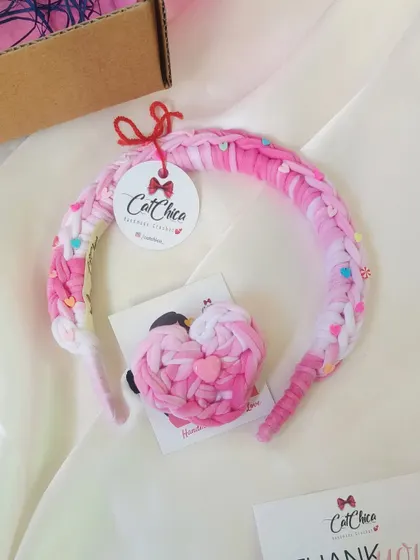 A pink version of our princess braids headband and heart hair tie set, complete with our branded tag.
