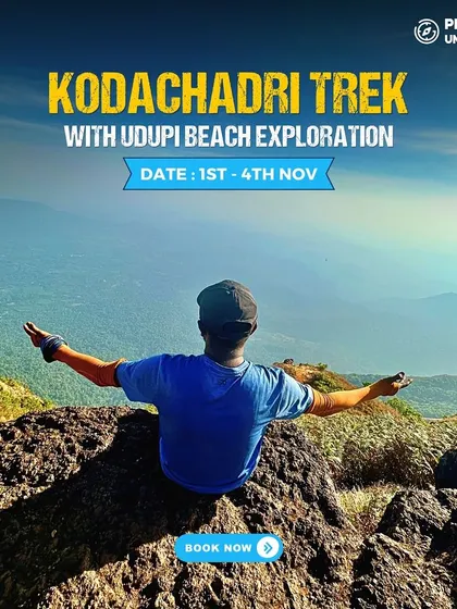 A trekker with arms wide open, embracing the panoramic view from the top of Kodachadri. This is freedom.