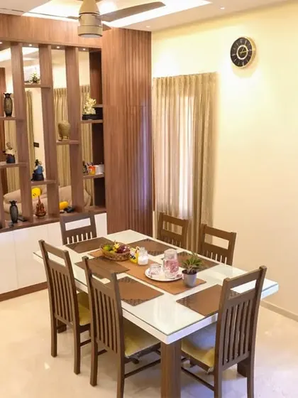 The dining area in the Velachery apartment, separated from the living room by a stylish wooden partition that also serves as a display shelf.