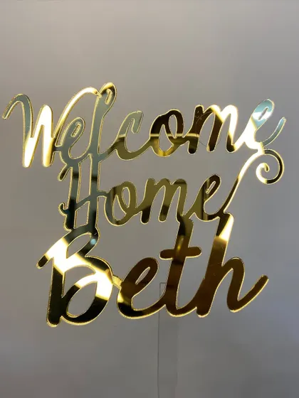 There's no place like home! This "Welcome Home Beth" topper in a beautiful gold script is a sweet way to celebrate someone's return.